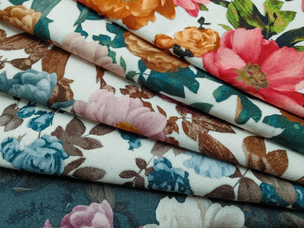 Fabrics printed with flowers of different colours folded and arranged in a fan shape