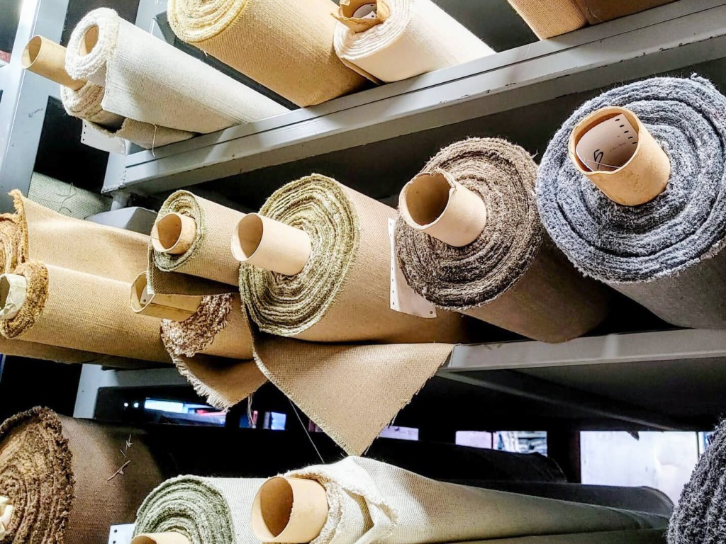 rolls of upholstery fabrics on shelves