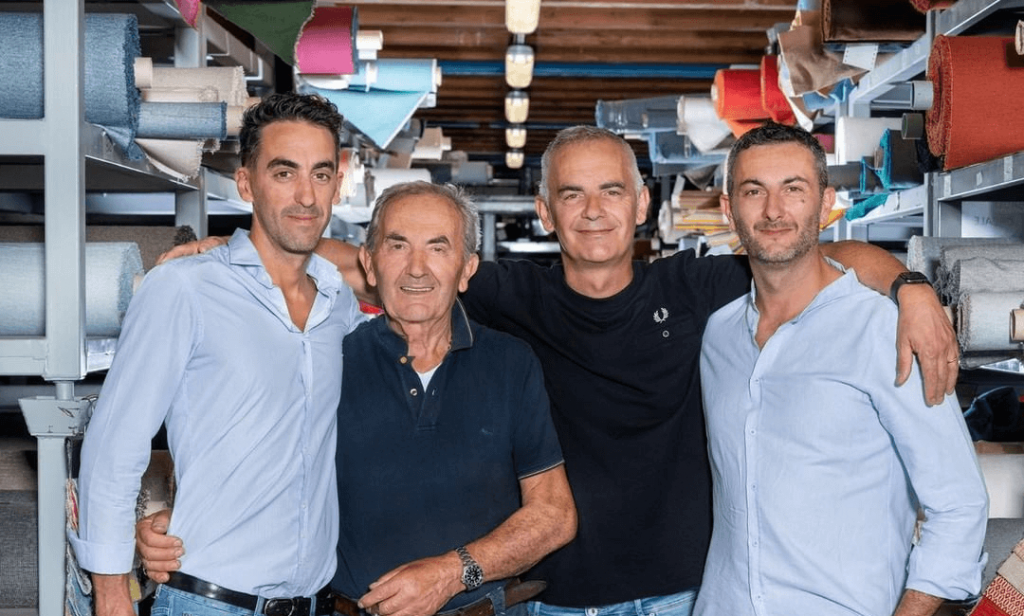 father and three sons portrayed in a textile warehouse